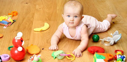 baby playing with a toy (girl 6 month)