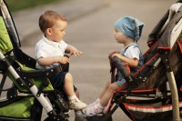 boy and girl in baby carriages