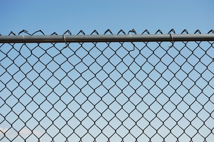 iron chainlink fence against sky