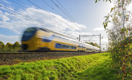Passenger train moving at high speed in sunlight