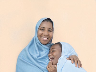 Mother and daughter smiling, maternal love and tenderness
