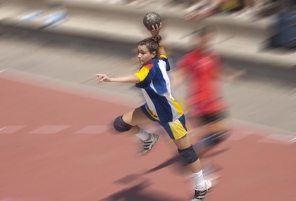 Handball player jumping with the ball