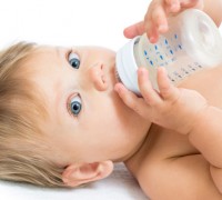 adorable baby drinking from bottle